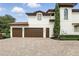 Exterior view of home with brick driveway and three-car garage at 1425 Dunbrooke Loop, Longwood, FL 32779