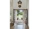 Grand foyer showcasing a decorative front door, high ceilings, and a view of the landscaped front yard at 1425 Dunbrooke Loop, Longwood, FL 32779