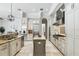 Bright kitchen with large island, stainless appliances, granite counters and tile flooring at 1425 Dunbrooke Loop, Longwood, FL 32779