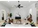 Open-concept living room with tile floors, neutral furniture and tiled staircase at 1425 Dunbrooke Loop, Longwood, FL 32779