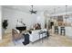 Bright, open living room flows into the kitchen with modern appliances and stylish pendant lighting at 1425 Dunbrooke Loop, Longwood, FL 32779