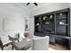 Well-lit home office with a built-in bookcase, stylish décor, and a comfortable seating area at 1425 Dunbrooke Loop, Longwood, FL 32779