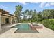 A beautiful in-ground pool with a spa is surrounded by lush landscaping at 1425 Dunbrooke Loop, Longwood, FL 32779