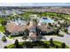 Aerial view of the community clubhouse with multiple pools and palm trees at 1439 Moon Valley Dr, Davenport, FL 33896