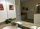 Detailed shot of a bathroom with granite counters and double sinks reflecting in mirror at 1439 Moon Valley Dr, Davenport, FL 33896