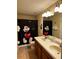 Bathroom featuring a dual sink vanity and shower with a Mickey Mouse themed shower curtain at 1439 Moon Valley Dr, Davenport, FL 33896
