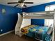 Bright bedroom with a Minions themed bunk bed featuring built in steps and storage at 1439 Moon Valley Dr, Davenport, FL 33896