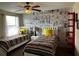 Charming bedroom featuring two twin beds and a whimsical Mickey Mouse comic strip wall at 1439 Moon Valley Dr, Davenport, FL 33896