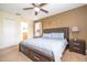 Main bedroom with a ceiling fan, neutral colors, and access to the ensuite bath at 1439 Moon Valley Dr, Davenport, FL 33896