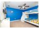 Bright bedroom with Minion-themed decor, bunk beds, and a ceiling fan at 1439 Moon Valley Dr, Davenport, FL 33896