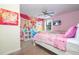 Pink bedroom with Disney princess decor, including custom wall art at 1439 Moon Valley Dr, Davenport, FL 33896