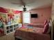 Lovely bedroom with two twin beds featuring colorful princess themed bedding and mural at 1439 Moon Valley Dr, Davenport, FL 33896