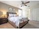 Cozy main bedroom with a ceiling fan, neutral colors, and ensuite bathroom access at 1439 Moon Valley Dr, Davenport, FL 33896