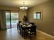 Elegant dining room with seating for eight and views of the pool area at 1439 Moon Valley Dr, Davenport, FL 33896