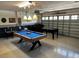 A game room is fully equipped with a pool table and a foosball table at 1439 Moon Valley Dr, Davenport, FL 33896