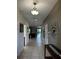 Inviting hallway with tiled flooring and stylish decor leading to the home's interior spaces at 1439 Moon Valley Dr, Davenport, FL 33896