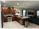 Modern kitchen with stainless steel appliances and a breakfast bar overlooking living area at 1439 Moon Valley Dr, Davenport, FL 33896
