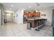 Open-concept kitchen with granite countertops, stainless steel appliances, and bar seating at 1439 Moon Valley Dr, Davenport, FL 33896