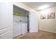 Bright laundry room with washer, dryer, and shelving with decorative items at 1439 Moon Valley Dr, Davenport, FL 33896
