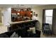Open concept living space with kitchen, bar, seating, stainless steel appliances, and modern finishes at 1439 Moon Valley Dr, Davenport, FL 33896