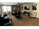 Spacious living room featuring comfortable leather sofas, a ceiling fan, and ample natural light at 1439 Moon Valley Dr, Davenport, FL 33896