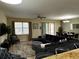 Comfortable living area with a large sectional sofa and views of the dining area and patio at 1439 Moon Valley Dr, Davenport, FL 33896