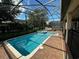 Sparkling pool and hot tub with brick paver decking and screened enclosure at 1439 Moon Valley Dr, Davenport, FL 33896