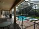 Sparkling pool and hot tub with brick paver decking and screened enclosure under lanai at 1439 Moon Valley Dr, Davenport, FL 33896