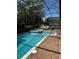 Sparkling pool and hot tub with brick paver decking and screened enclosure at 1439 Moon Valley Dr, Davenport, FL 33896