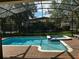 Sparkling pool and hot tub with brick paver decking and screened enclosure at 1439 Moon Valley Dr, Davenport, FL 33896