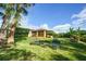 Lush backyard with manicured lawn, trees, outdoor seating, and view of the home at 149 Spanish Bay Dr, Sanford, FL 32771