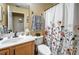 Neat bathroom featuring a vanity, toilet, and a shower with a floral curtain at 149 Spanish Bay Dr, Sanford, FL 32771