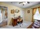 Comfortable bedroom featuring a ceiling fan, cream walls and carpet, and a desk area at 149 Spanish Bay Dr, Sanford, FL 32771