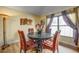 Cozy dining room features a round wood table with comfortable seating, a decorative floral centerpiece, and natural light at 149 Spanish Bay Dr, Sanford, FL 32771