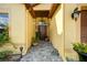Charming doorway featuring stone walkway, potted plants and decorative sconce lighting at 149 Spanish Bay Dr, Sanford, FL 32771