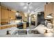 Well-lit kitchen with stainless steel appliances, light wood cabinetry, white countertops, and stylish decor on yellow painted walls at 149 Spanish Bay Dr, Sanford, FL 32771