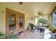 Relaxing screened-in lanai with tile floor, seating, and a ceiling fan at 149 Spanish Bay Dr, Sanford, FL 32771