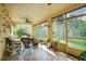 Relaxing screened-in lanai with comfortable seating, potted plants, and a ceiling fan at 149 Spanish Bay Dr, Sanford, FL 32771