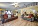 Spacious living room showcasing an open layout with two leather sofas, hardwood flooring, and neutral decor at 149 Spanish Bay Dr, Sanford, FL 32771