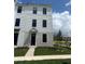 Modern townhouse showcasing a black front door and landscaping at 15095 Grove Lake Dr, Winter Garden, FL 34787