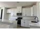 Contemporary kitchen featuring sleek white cabinets and stainless steel appliances at 15095 Grove Lake Dr, Winter Garden, FL 34787