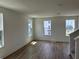 Bright living room with wood floors and multiple windows at 15095 Grove Lake Dr, Winter Garden, FL 34787