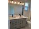 Stylish bathroom featuring a double sink vanity, quartz countertop, and modern fixtures at 15107 Grove Lake Dr, Winter Garden, FL 34787