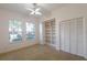 Bright bedroom with two large windows, built-in bookshelf, and a ceiling fan at 1586 Antoinette Ct, Oviedo, FL 32765