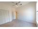 A bright bedroom with neutral carpet and a ceiling fan with a light fixture at 1586 Antoinette Ct, Oviedo, FL 32765