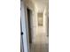 Long hallway featuring tile floors and multiple doorways at 1586 Antoinette Ct, Oviedo, FL 32765