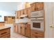 Kitchen with oak cabinets, white appliances, and breakfast bar at 1586 Antoinette Ct, Oviedo, FL 32765