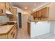 Kitchen featuring light oak cabinets, white countertop, and breakfast bar area at 1586 Antoinette Ct, Oviedo, FL 32765