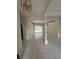 Spacious living room with tile flooring, decorative chandelier, and view of the pool area at 1586 Antoinette Ct, Oviedo, FL 32765