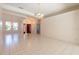 Spacious living room features tile flooring, classic chandelier, and a view of the front entrance at 1586 Antoinette Ct, Oviedo, FL 32765